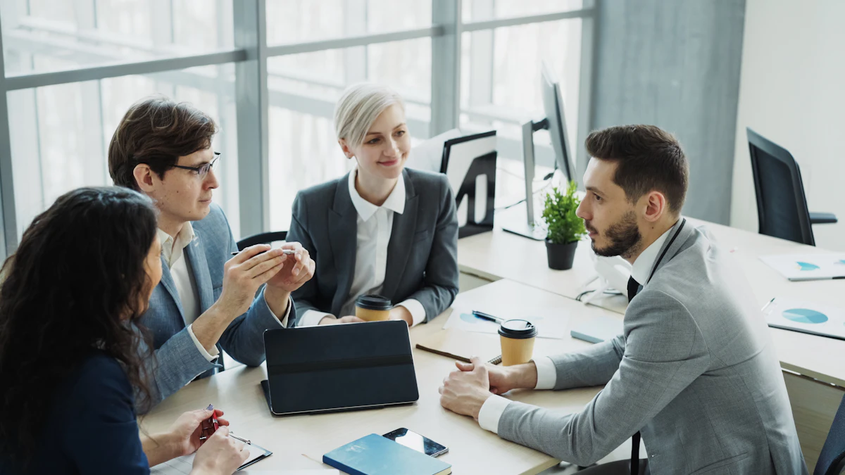 A business team reviewing work together around a meeting table in a modern office
