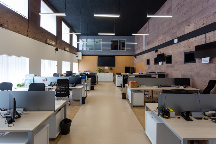 Open-plan office with rows of desks and workstations